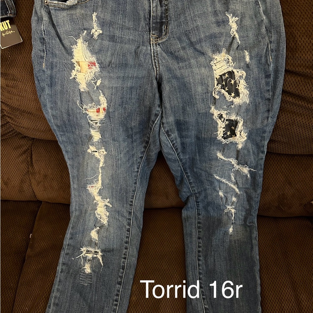 Ripped jeans with red white and blue going through